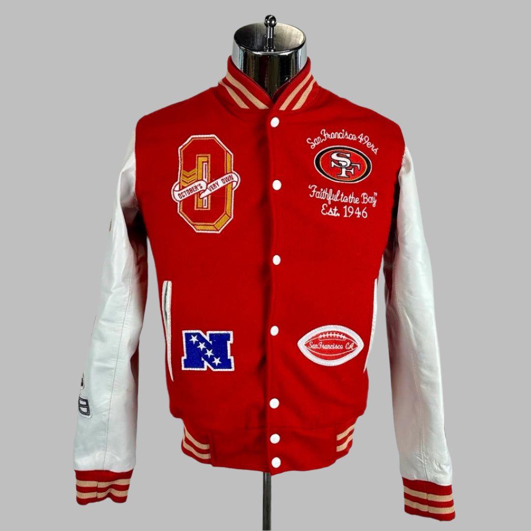 Front of varsity jacket with red body, white sleeves, San Francisco 49ers  logo stitched onto breast, with other novelty patches.