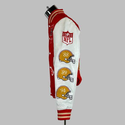 Side view Backside of varsity jacket with red body, white sleeves with three helmet patches down sleeve under NFL shield. 