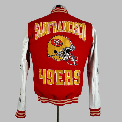 Backside of varsity jacket with red body, white sleeves, San Francisco 49ers & logo stitched onto back.