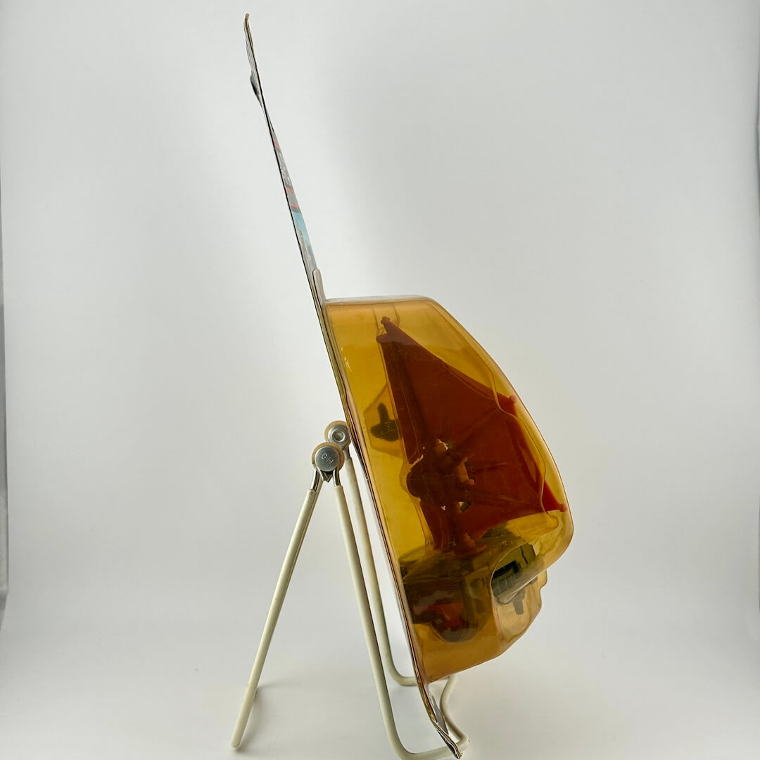 Side view of Star Wars toy in packaging on easel against white background. 