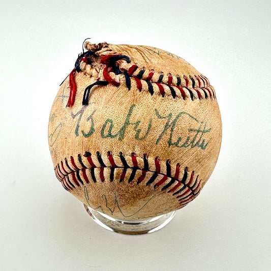Vintage baseball with 'Babe Ruth' signature on a white background