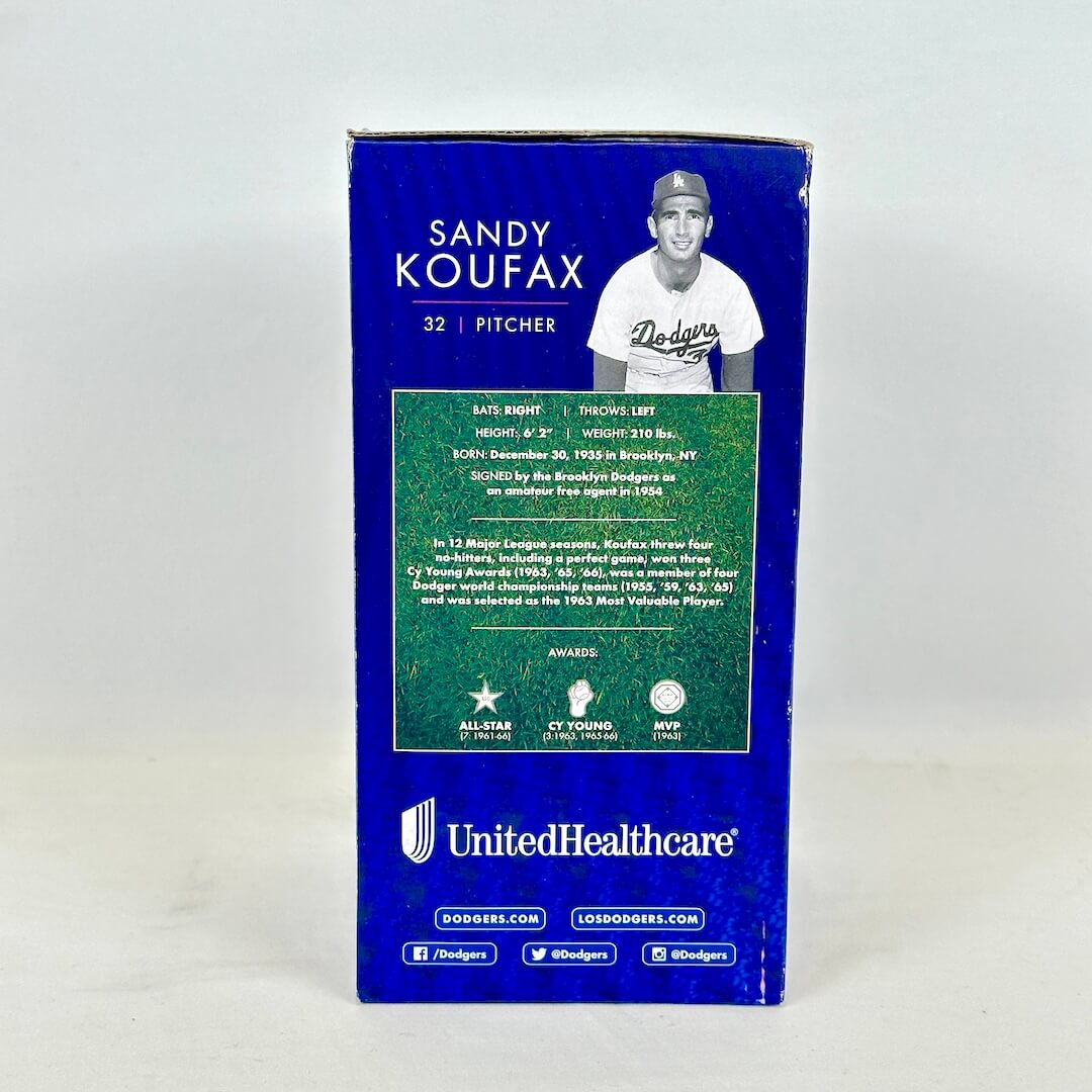 A blue cardboard box featuring Sandy Koufax information, with a black-and-white photo of the pitcher.