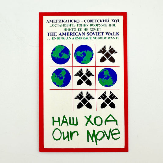 Backside of laminate card with tic-tac-toe game with bombs and EArths as the tokens, with Cyrillic and English text at top and bottom. 