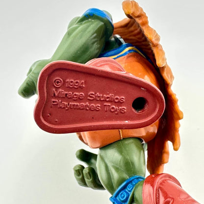 Toy figure with a red label displaying '1994 Mirage Studios Playmates Toys' on a white background