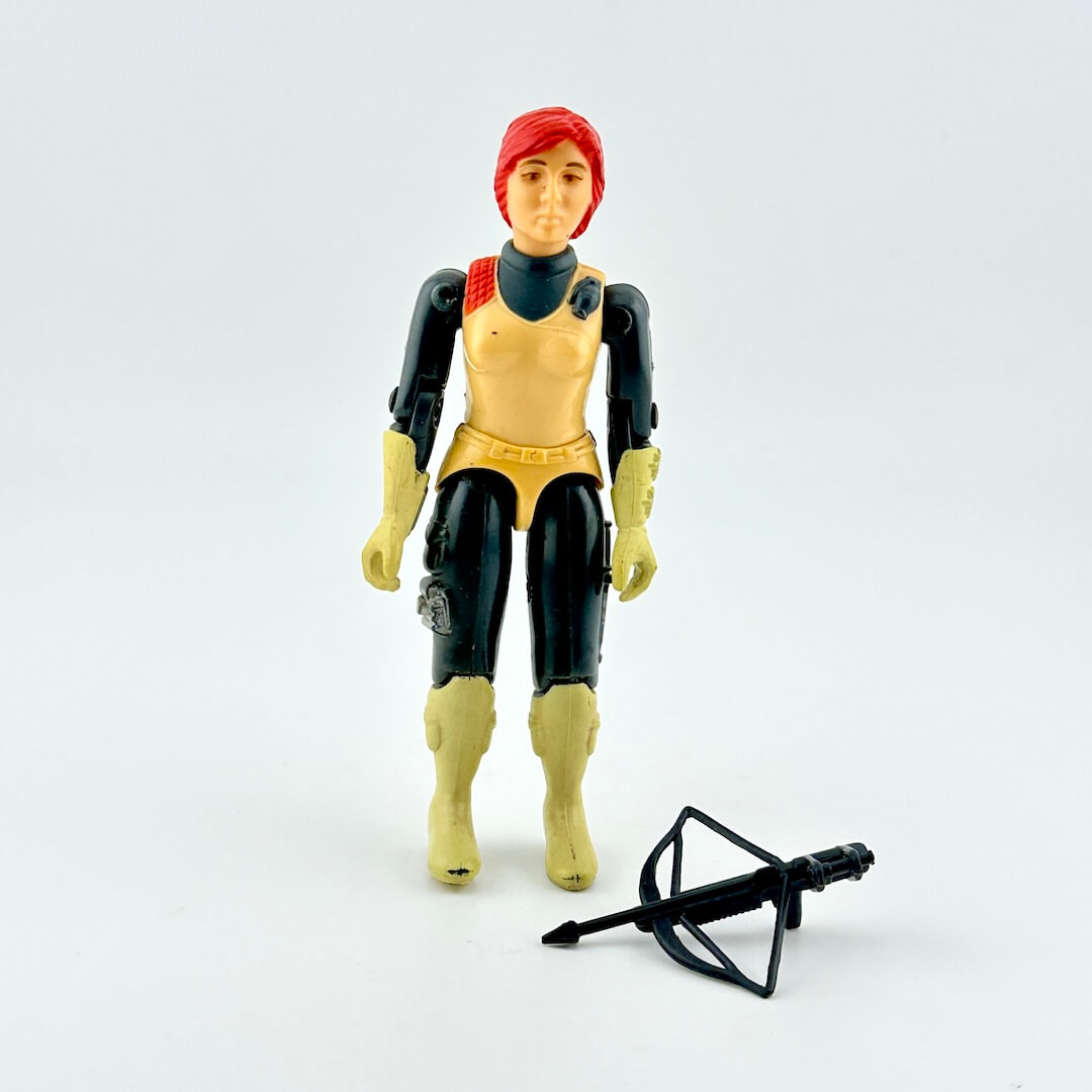 Toy figure with red hair and yellow outfit on a white background