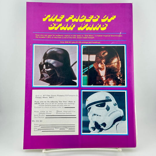 Vintage Star Wars magazine with character helmets on a purple background