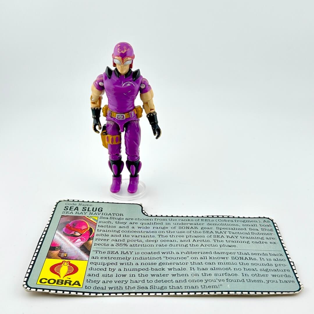 Action figure in purple costume with a Cobra branded card on a white background