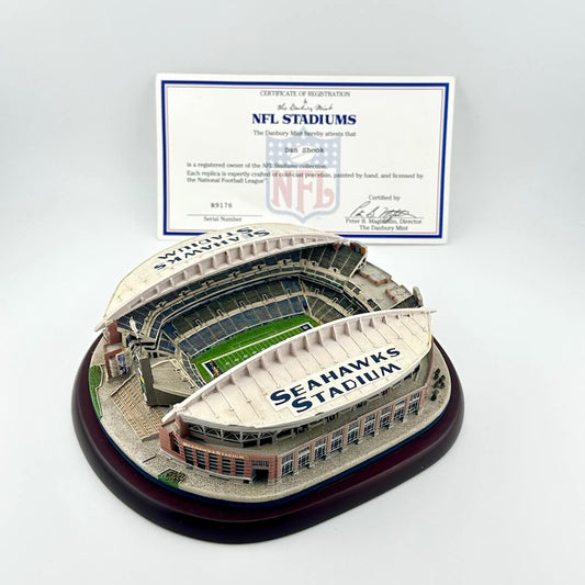 Model of a stadium with 'Seahawks Stadium' on it, featuring an NFL certificate of registration.