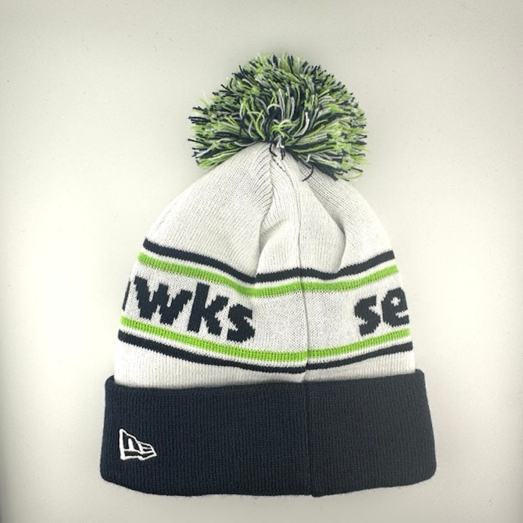 White knit cap with green/navy stripes around navy team name, Seahawks logo in center of navy cuff & green/navy/white pom