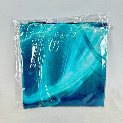 Blue marbled bandana in clear plastic packaging on a light gray background
