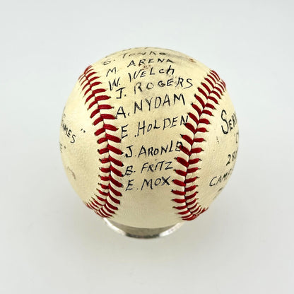 A white leather baseball with red stitching, signed with black ink names. 