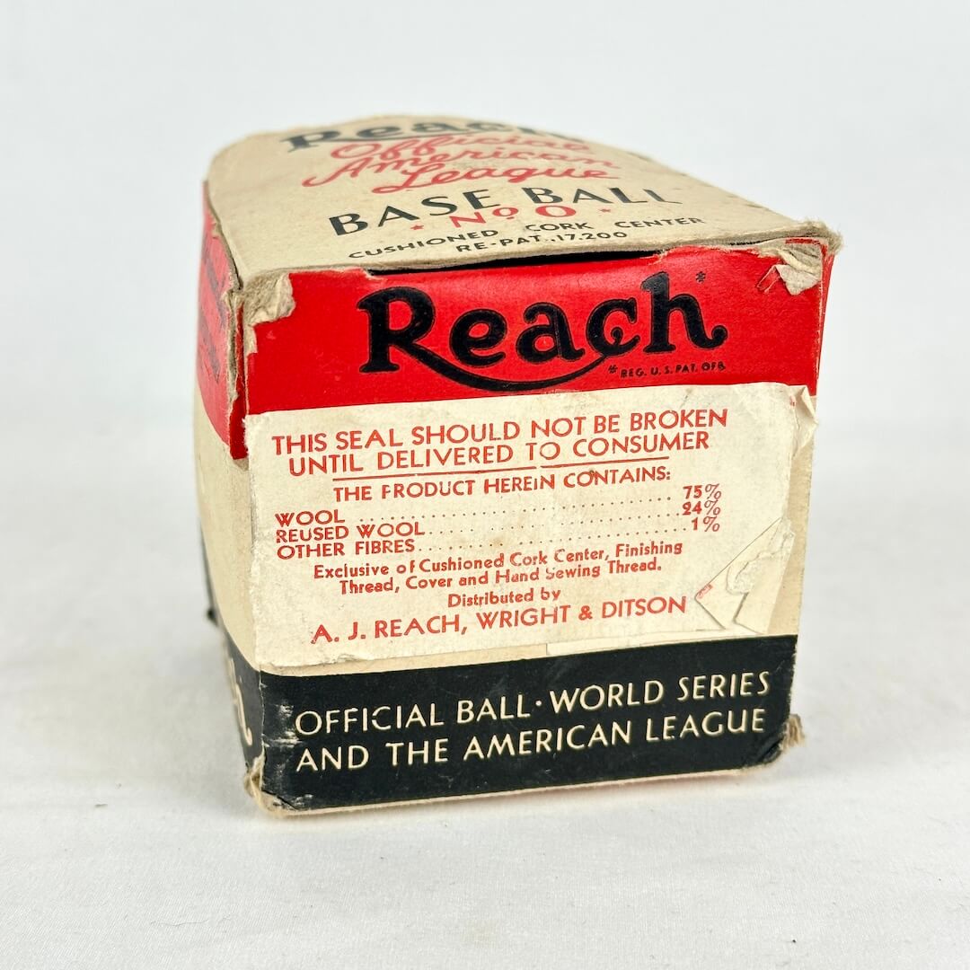 Vintage Reach Base Ball packaging box with red, cream, and black sections, showing text.