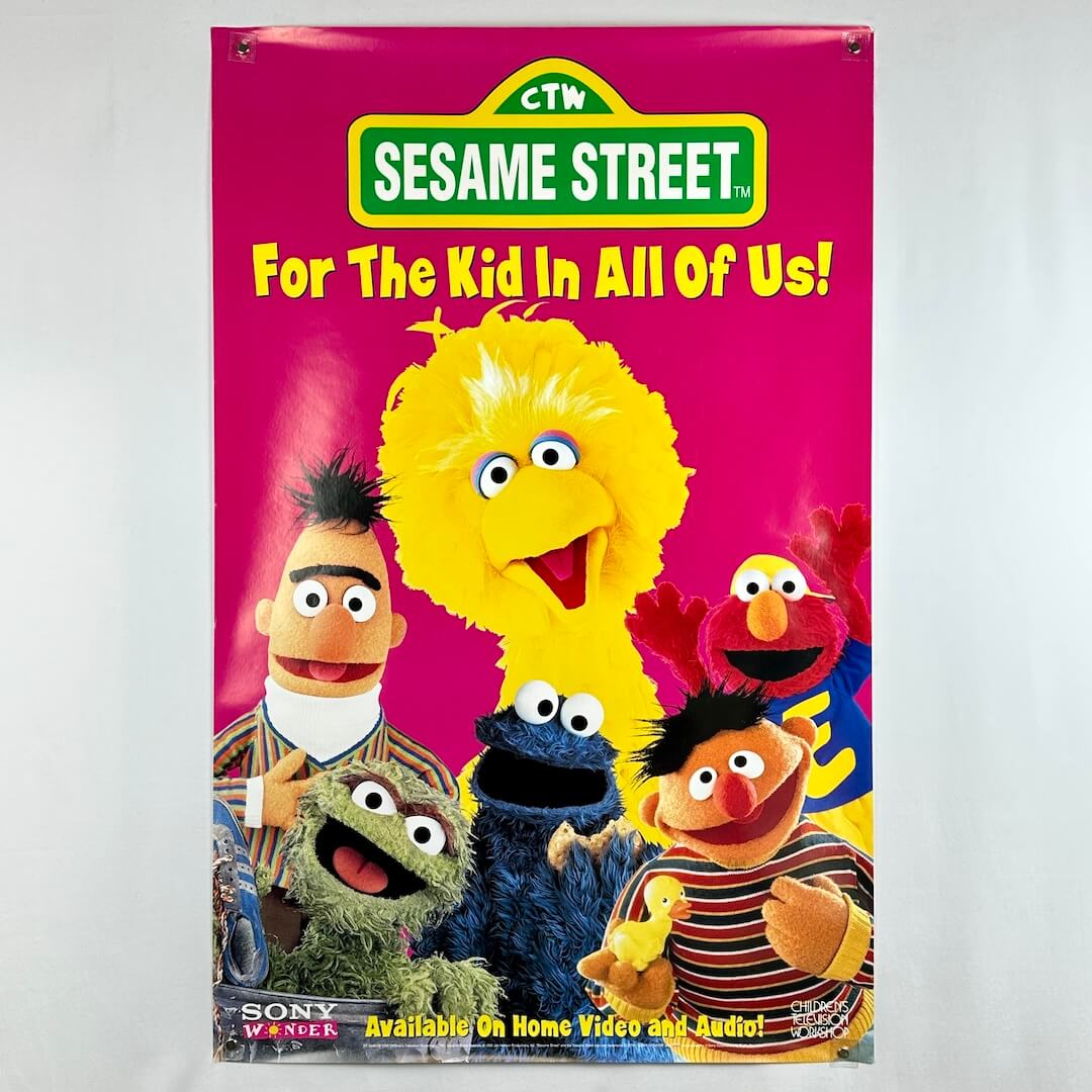 Sesame Street promotional poster with colorful characters on a pink background
