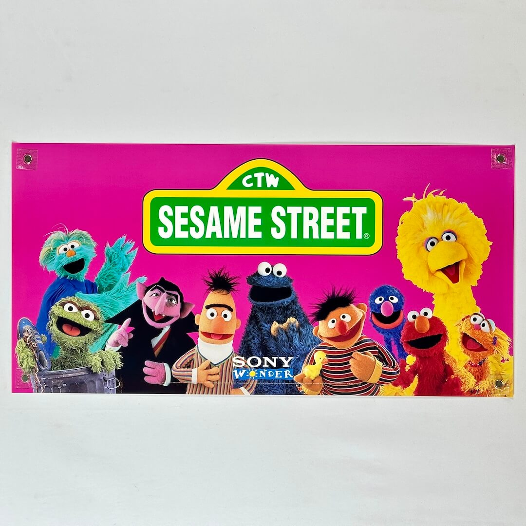 Sesame Street banner with characters on a pink background