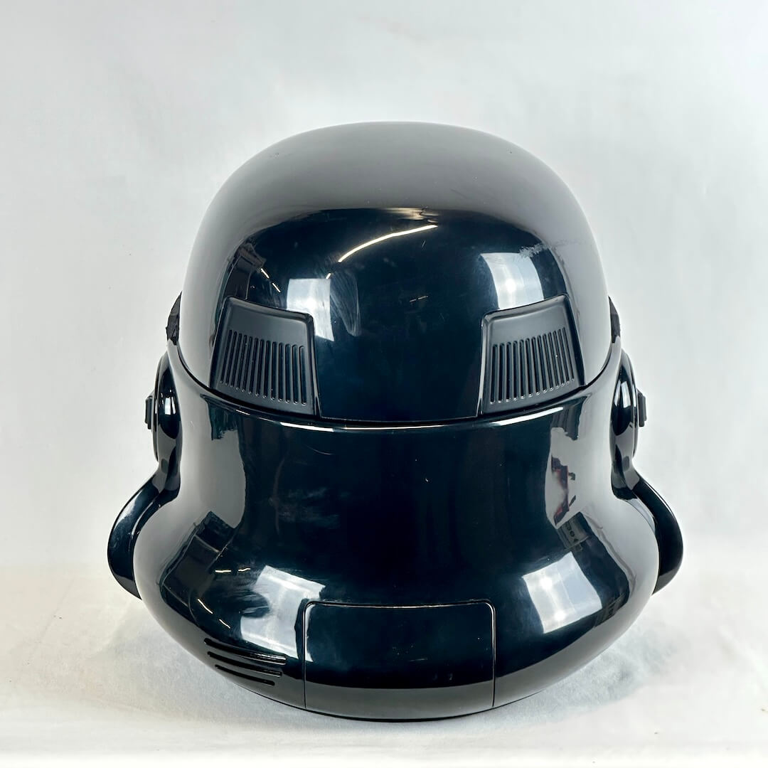 Glossy black Stormtrooper helmet photographed from the back on light background. 