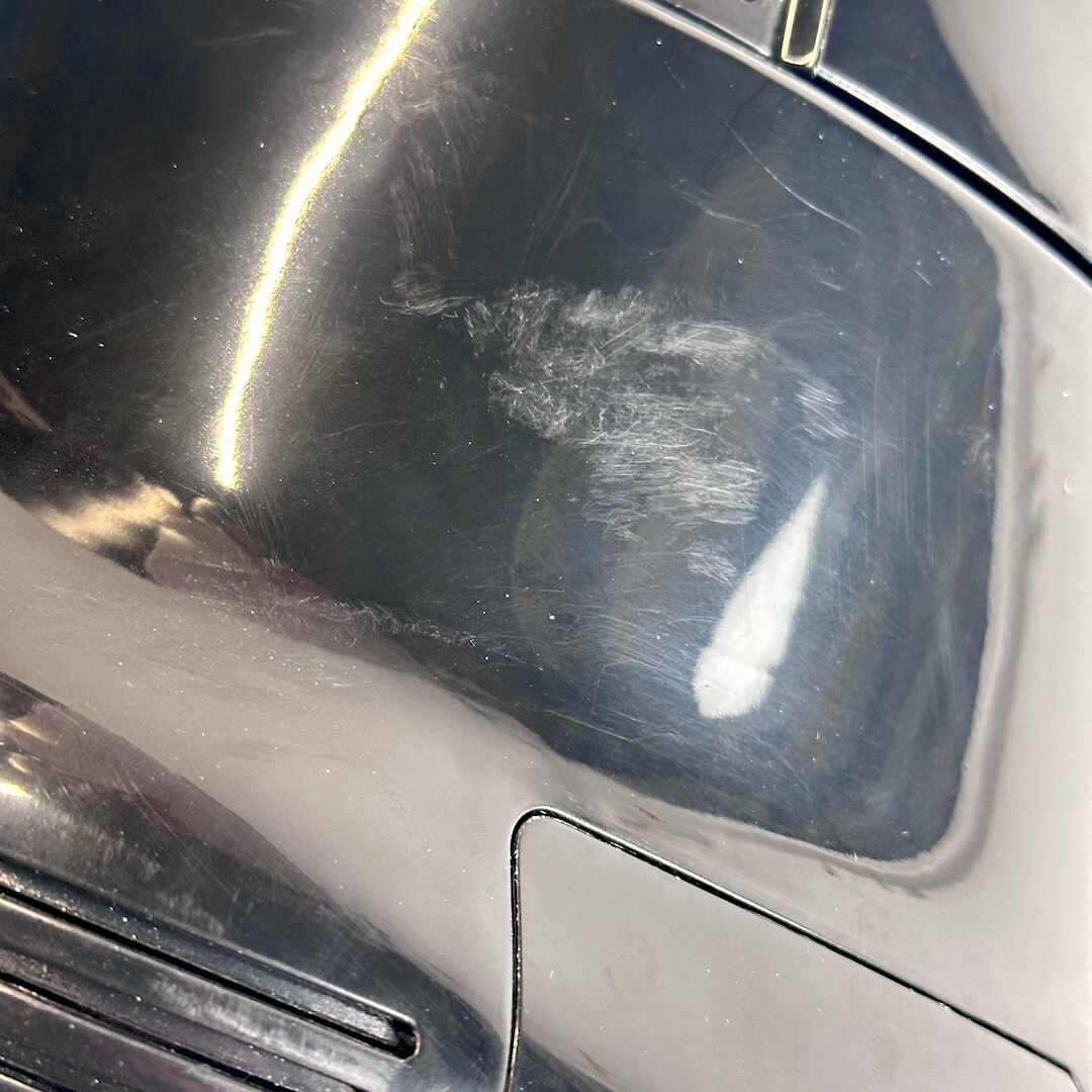 Close-up of scuffs on backside of  black stormtrooper helmet.