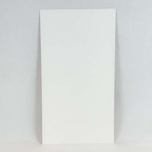 Backside of art print showing white rectangular paper photographed on white background. 