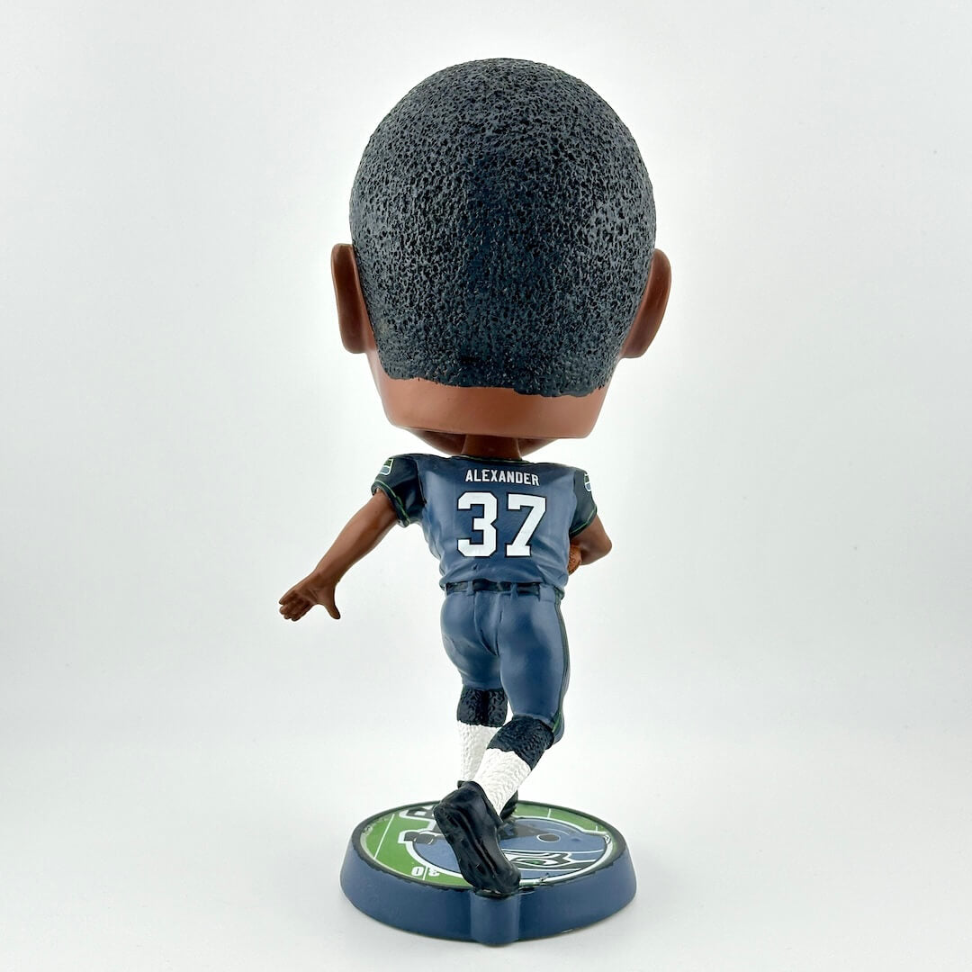Bobblehead figure of a sports player in a blue uniform on a white background