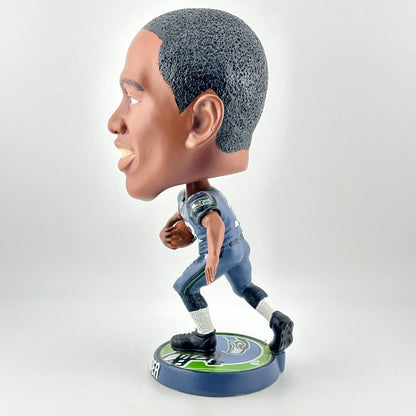 Bobblehead figure of a sports player in a blue uniform on a white background