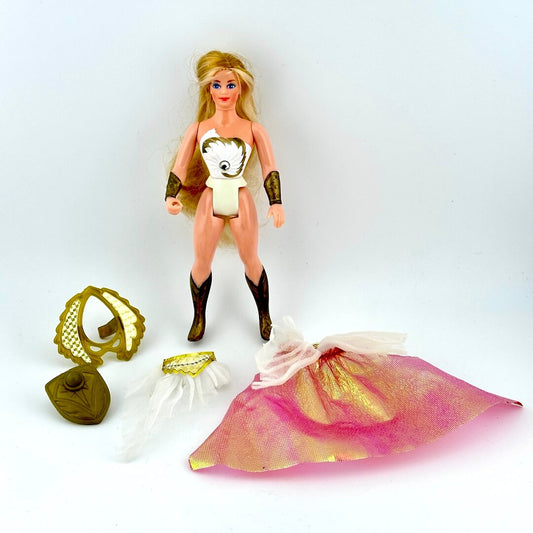Blonde She-Ra doll with accessories on white background.