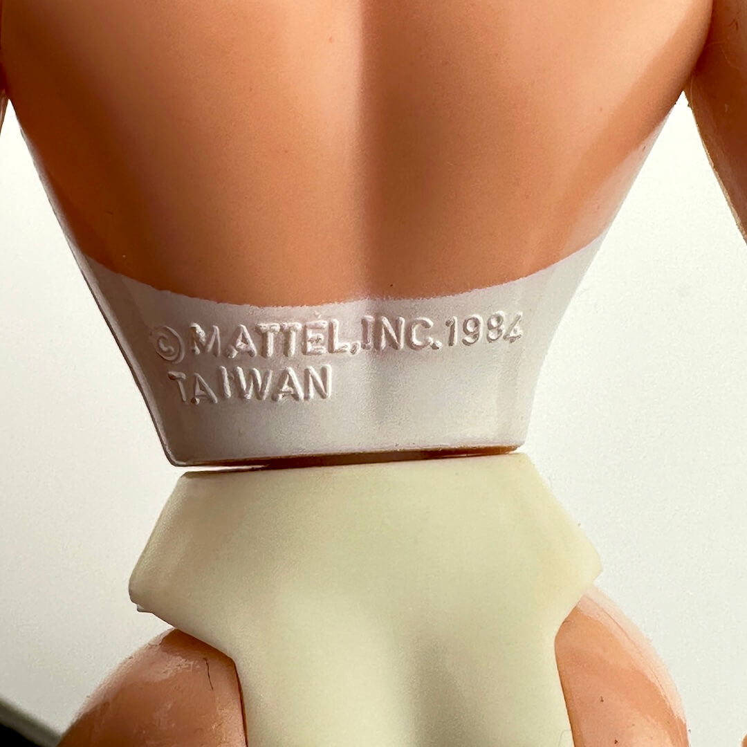 Back of doll's waist showing the copyright and COO information. 