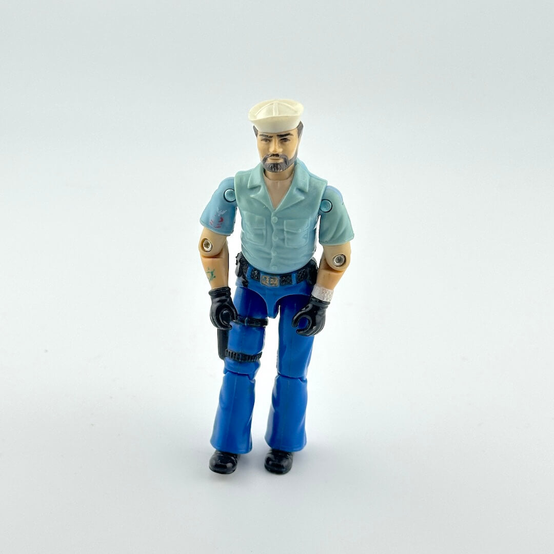 Action figure wearing a light blue shirt and blue pants on a white background