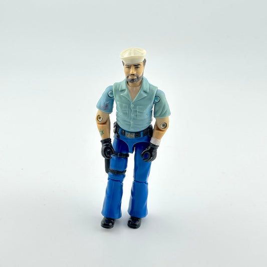 Action figure wearing a light blue shirt and blue pants on a white background