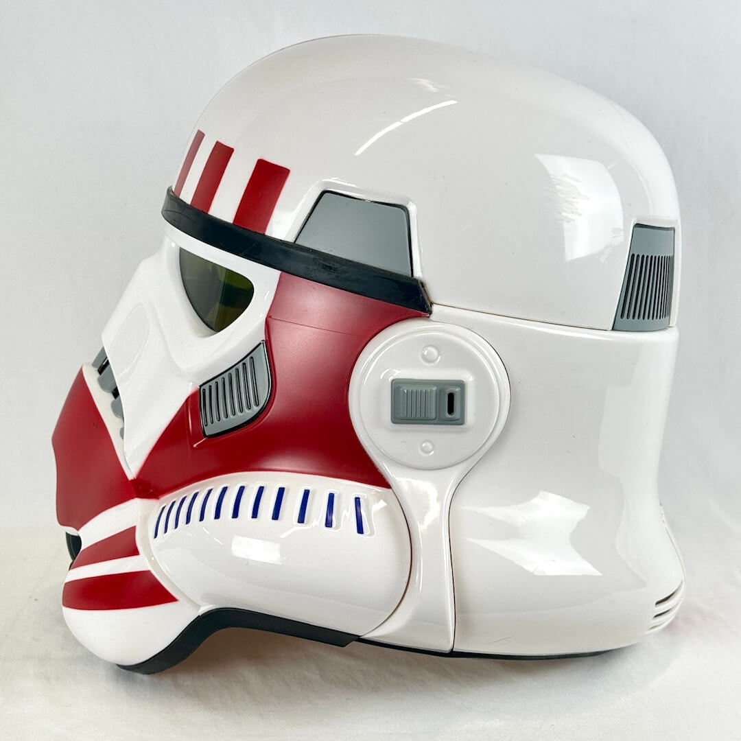 A glossy white and red sci-fi helmet, styled like a stormtrooper with red stripes and markings.