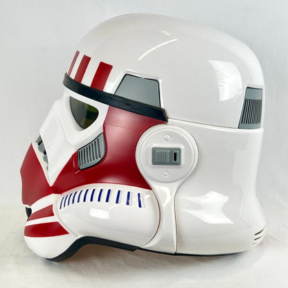 A glossy white and red sci-fi helmet, styled like a stormtrooper with red stripes and markings.