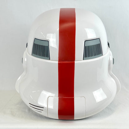 A glossy white helmet with a bold vertical red stripe down the center and gray vent details on the sides.