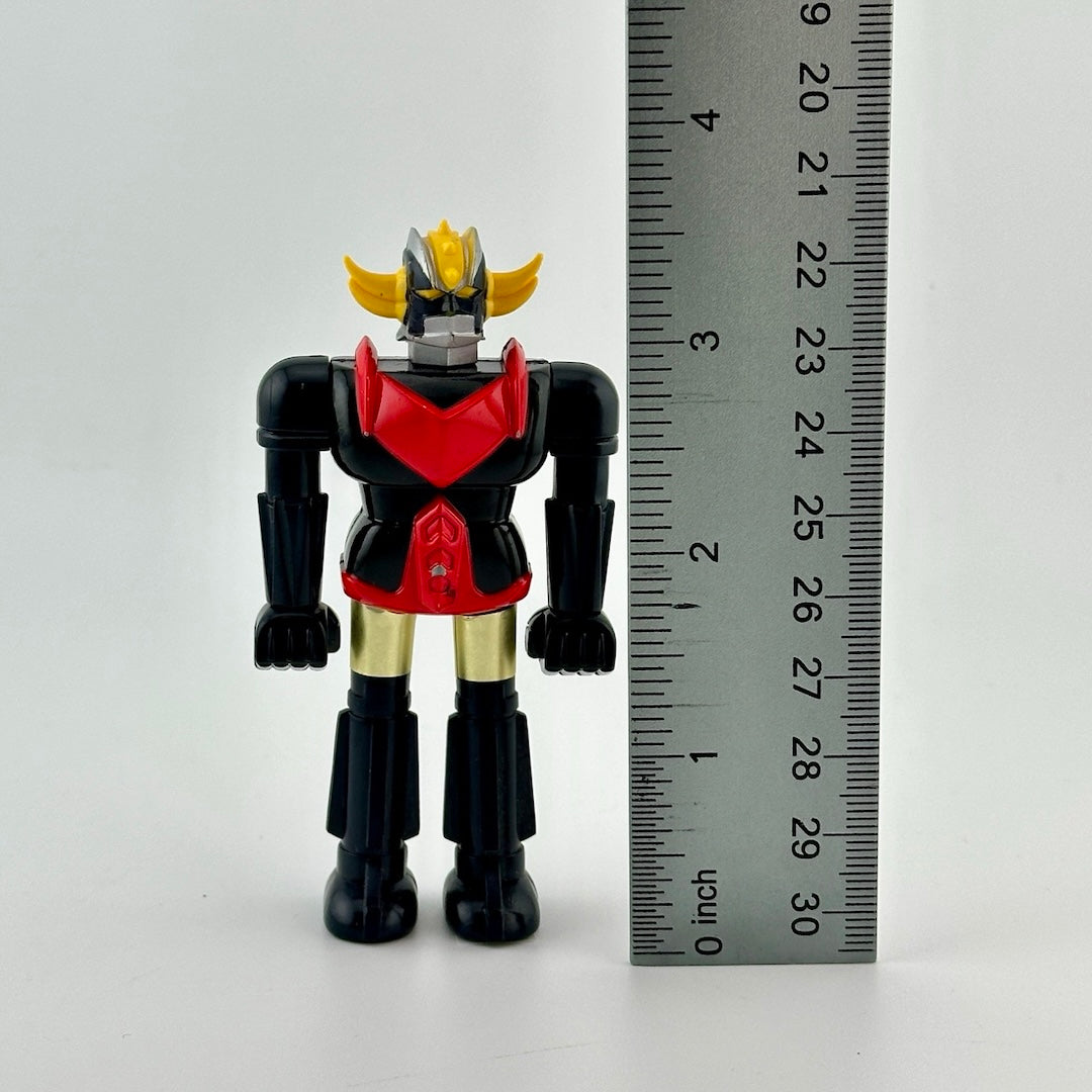 Image of 3.5 inch robot action figure standing next to ruler to show figure height.