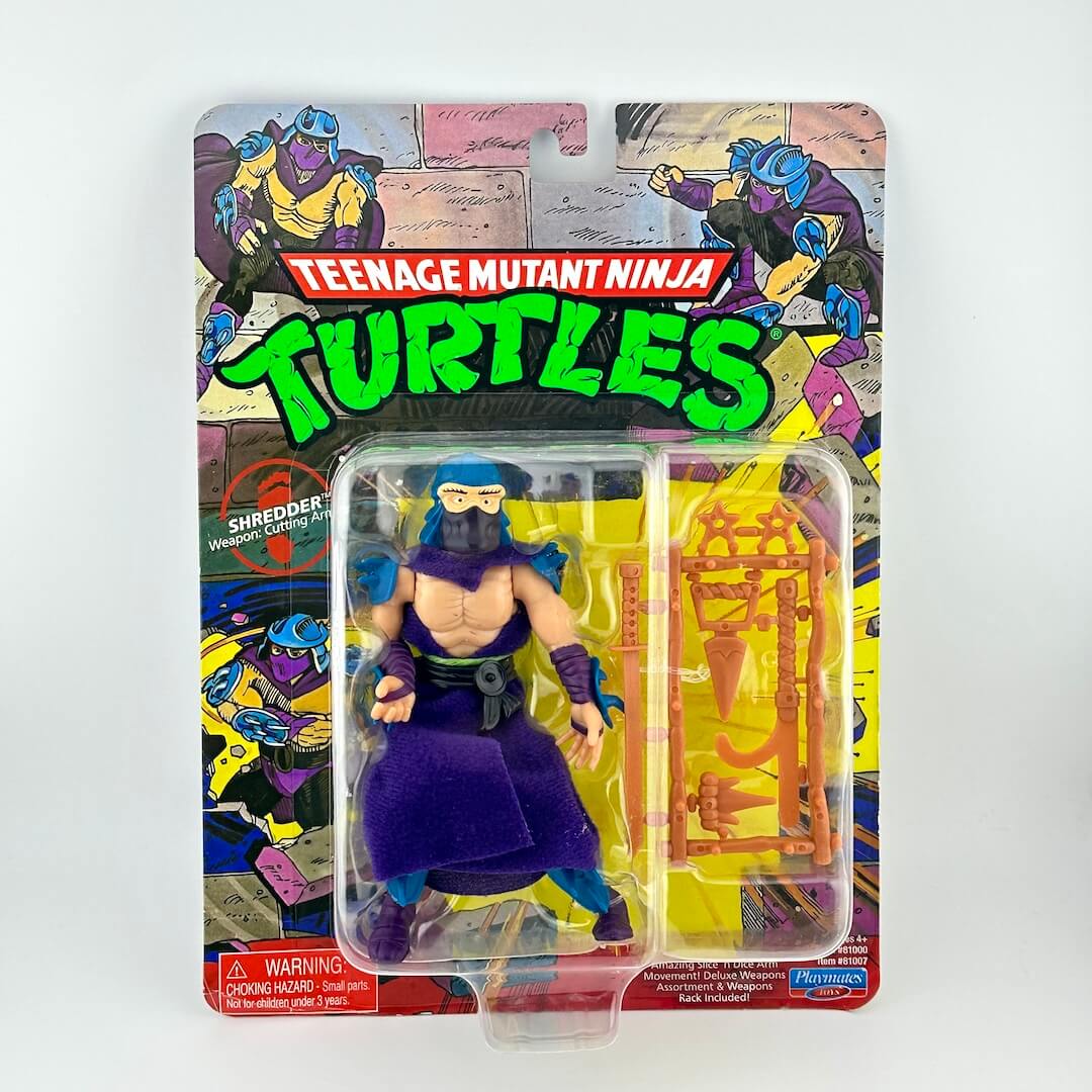 Teenage Mutant Ninja Turtles Shredder action figure in original blister card packaging, featuring a purple ninja outfit.