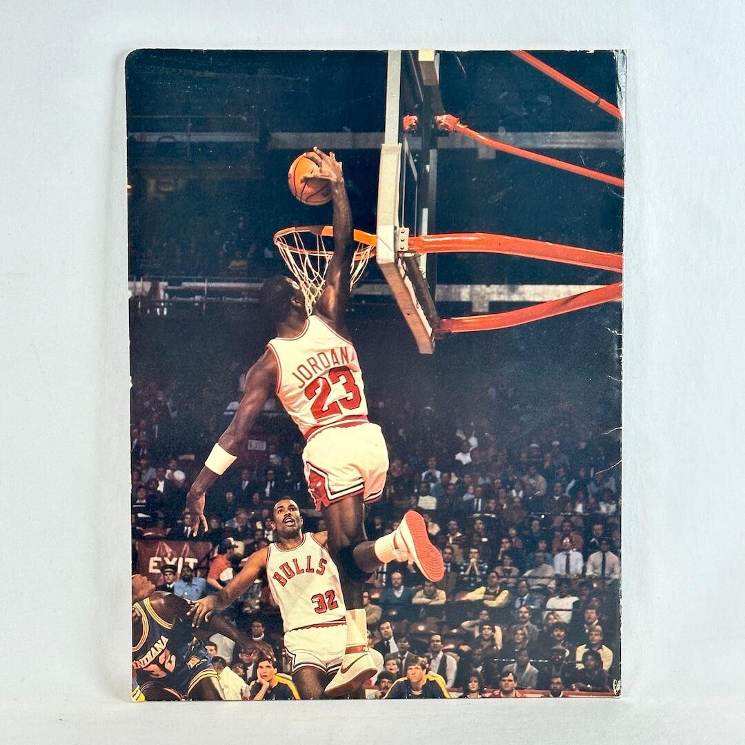 Basketball player in action with a crowd in the background on folder.