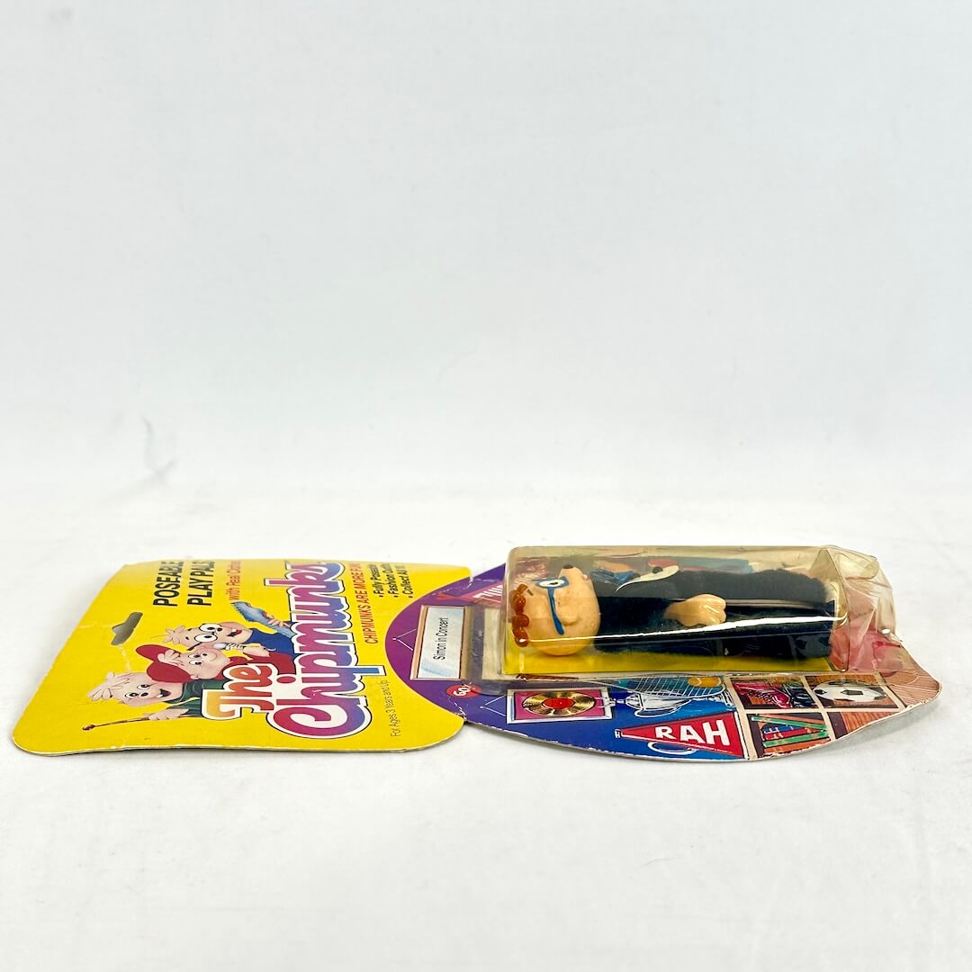 Vintage toy figure in packaging on a white background