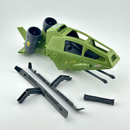 An olive green toy fighter jet model with black engines and accessories, displayed on a clean white background.