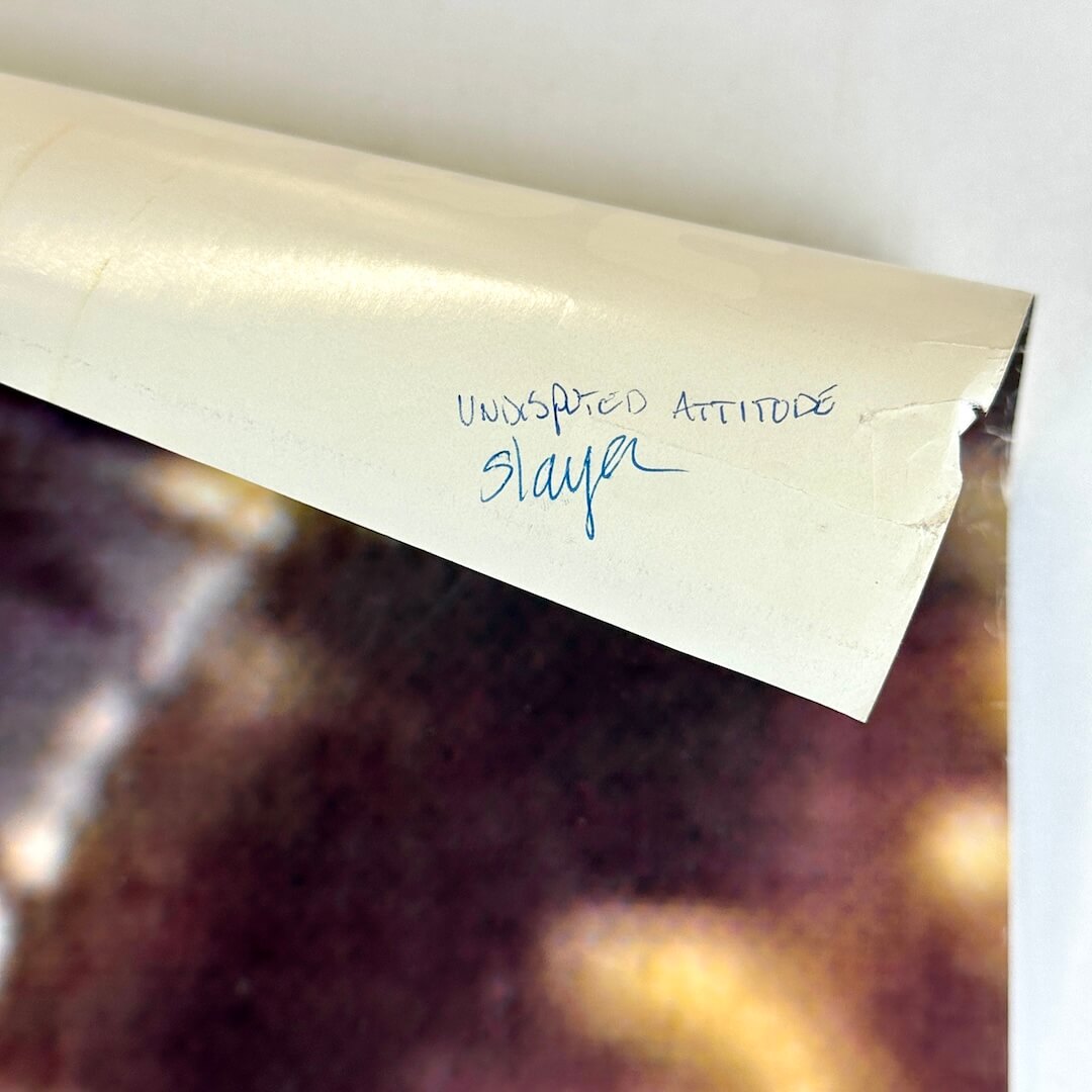 Top right corner rolled down to show pen note on reverse side. 
