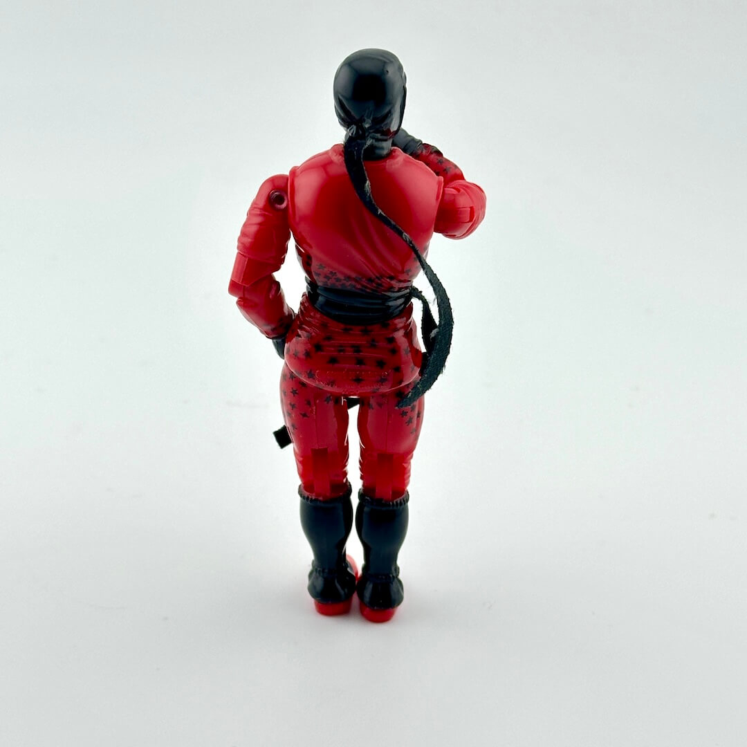 Action figure in red and black outfit on a white background