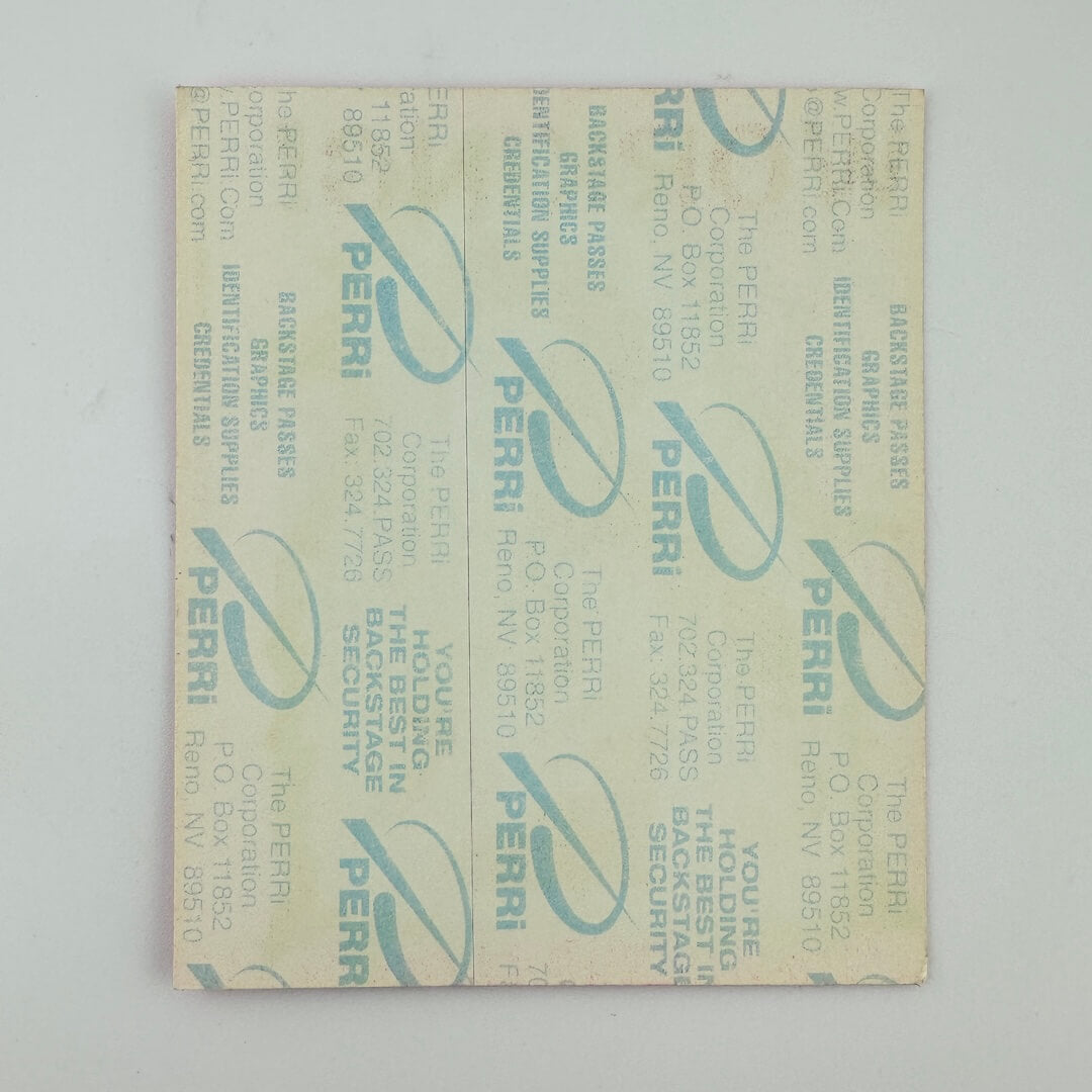 Backside of concert pass showing backing intact, against white background. 