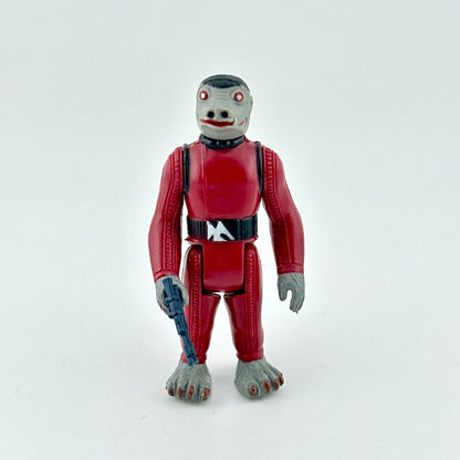 Toy figure in a red suit with gray hands and feet on a white background