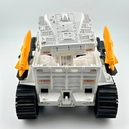 Back view of toy vehicle with missiles and missile box. 