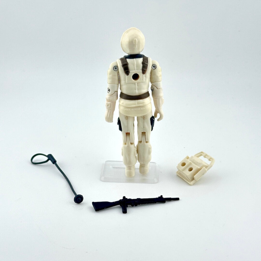 Toy figure in a white suit with accessories on a light gray background