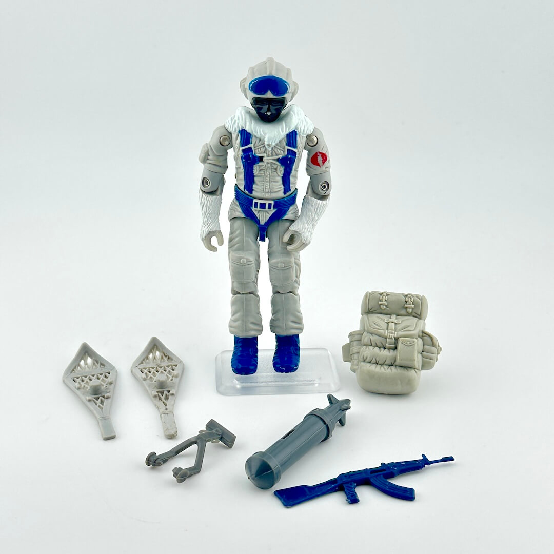 GI Joe action figure with accessories against white background. 