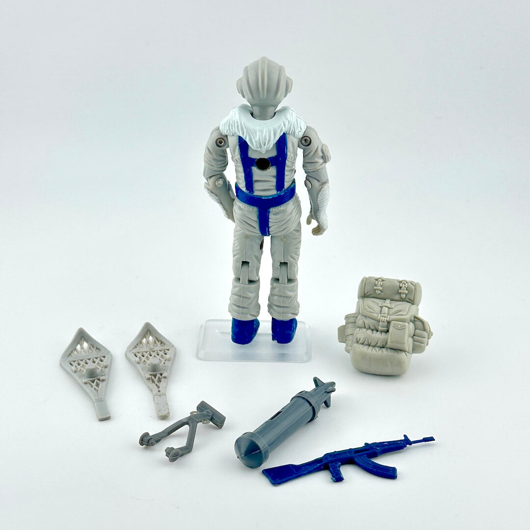 GI Joe action figure with accessories against white background. 