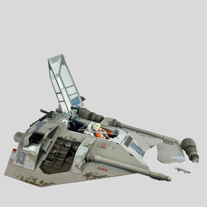 Star Wars Snowspeeder scaled model with pilot, open hatches, and attachments on light gray background. 