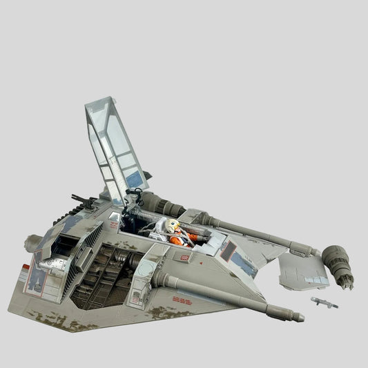 Star Wars Snowspeeder scaled model with pilot, open hatches, and attachments on light gray background. 