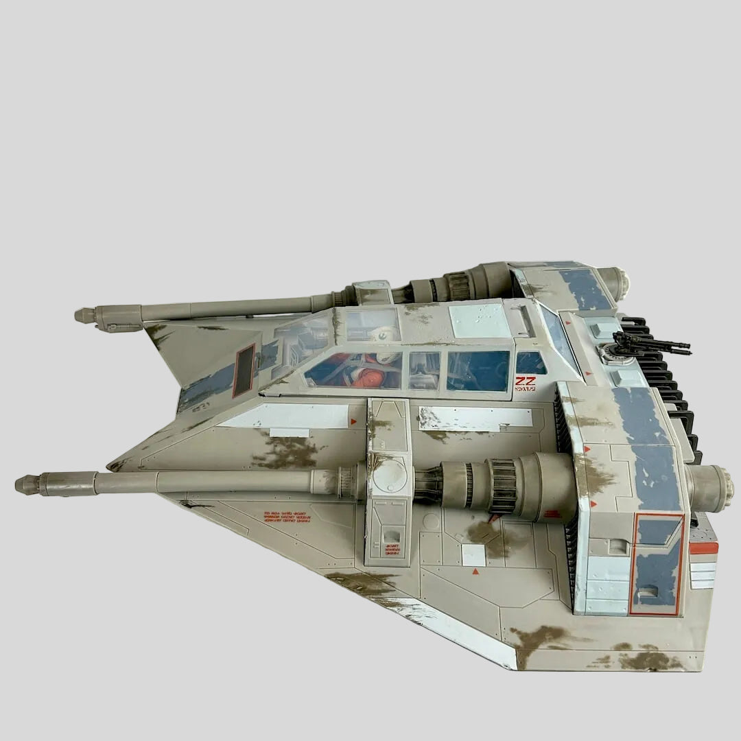 A detailed model of a weathered desert camouflage schemed vehicle, photographed from the side.