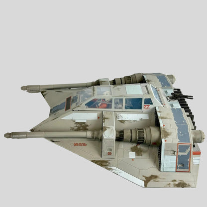 A detailed model of a weathered desert camouflage schemed vehicle, photographed from the side.