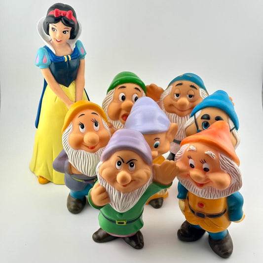 Snow White and the Seven Dwarfs figurines on a white background