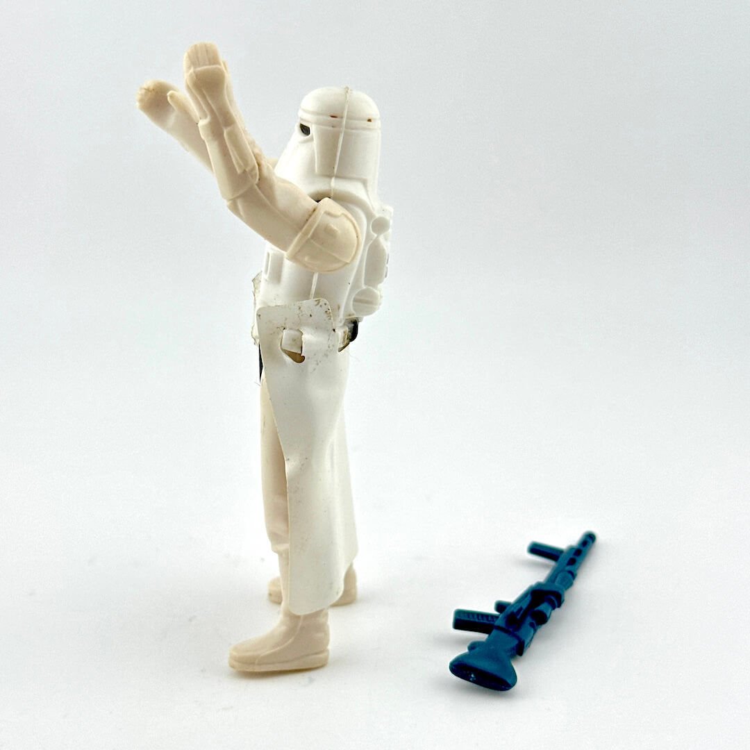 White action figure with a blue weapon on a white background