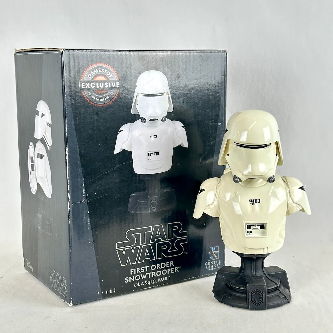 Star Wars First Order Snowtrooper collectible bust in cream plastic next to its original dark gray packaging box.